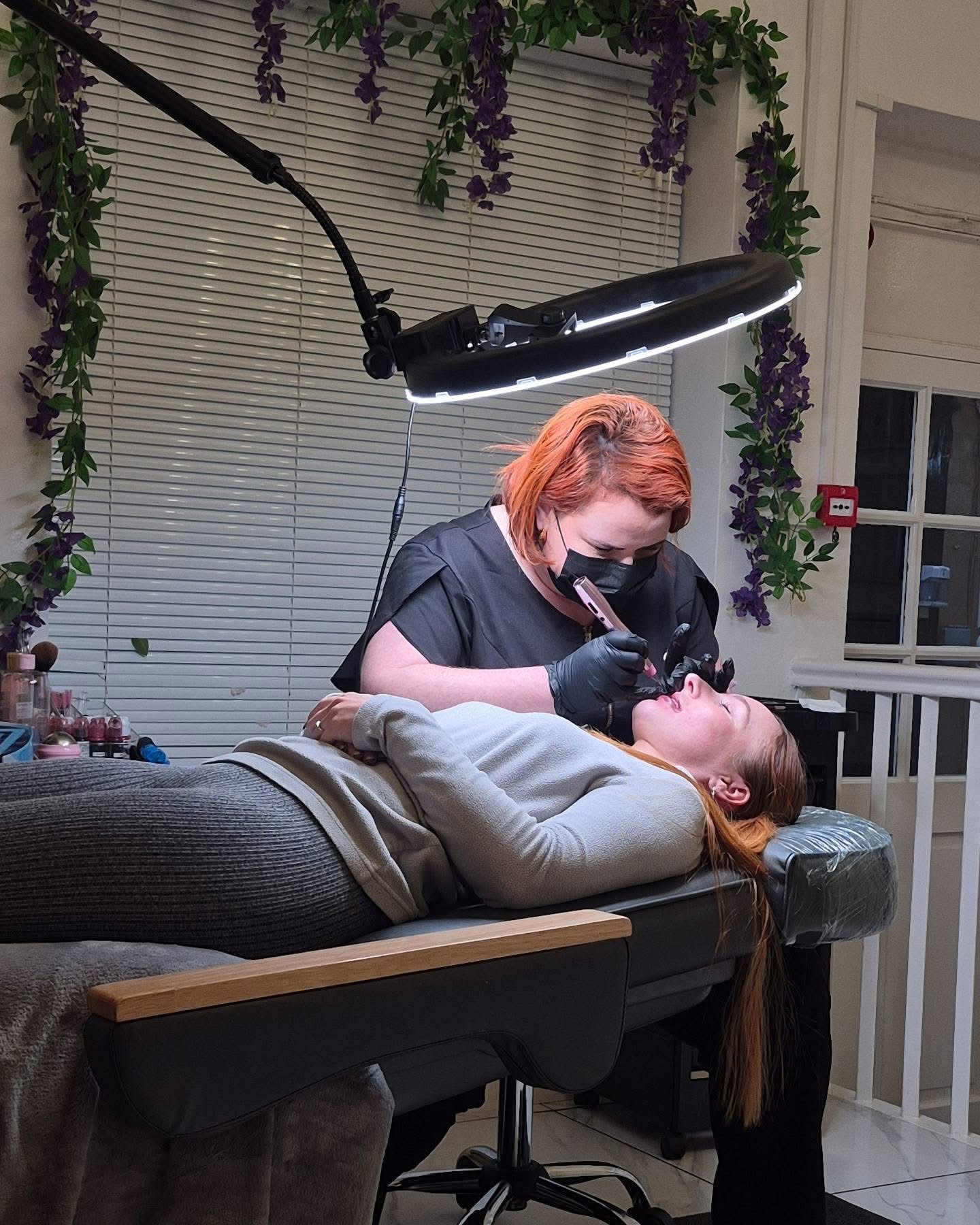 Lip blush student working on a live model