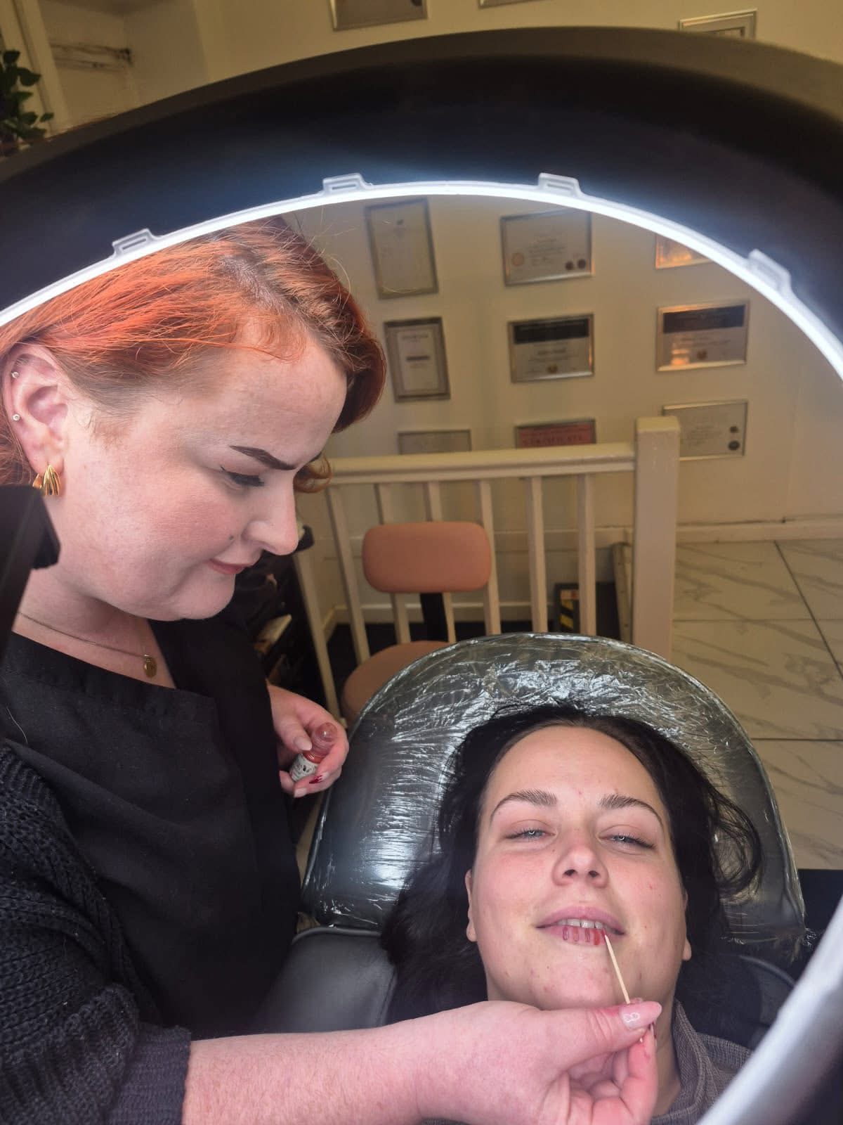 Student carrying out lip blush treatment
