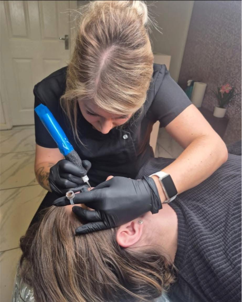 Student performing machine brow treatment